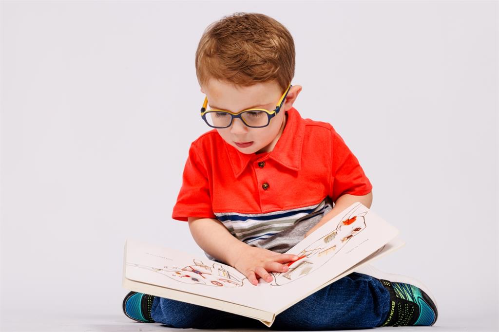 Young boy reading a book