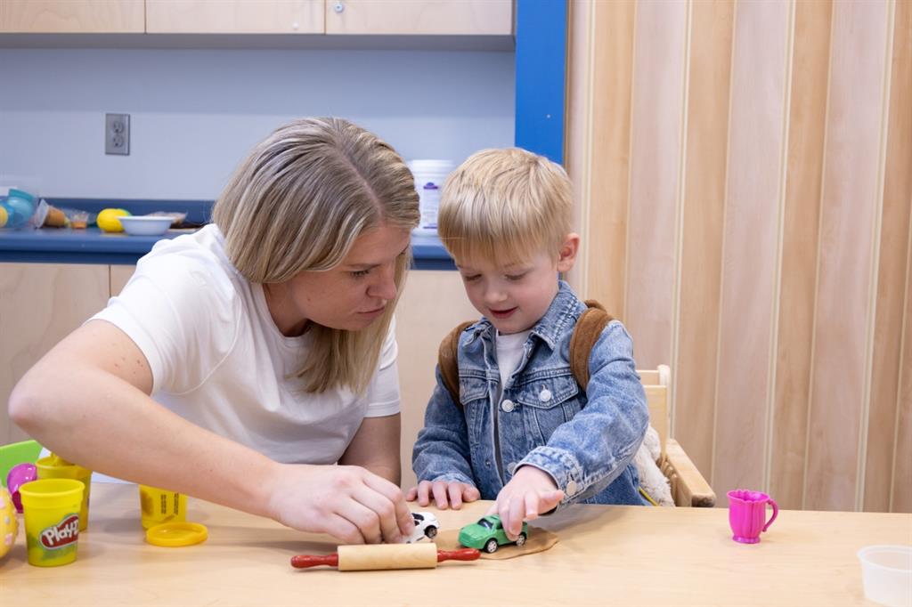 Mother playing with son at a table