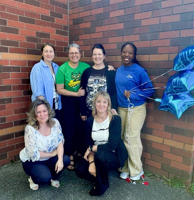 Group of women in front of brick wall