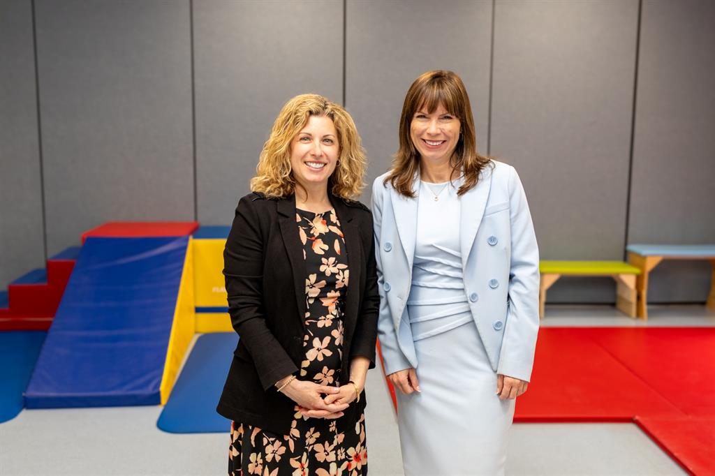 Two women in front of therapy equipment