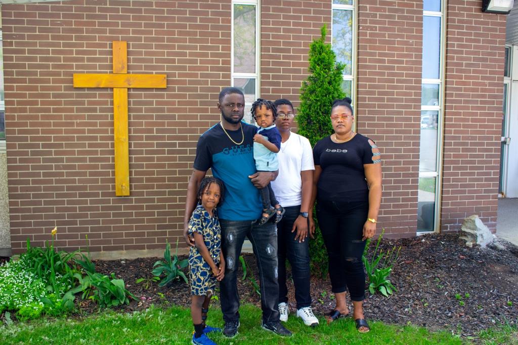 Family of five in front of brick wall