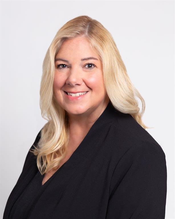 Women in black top in front of a white backdrop