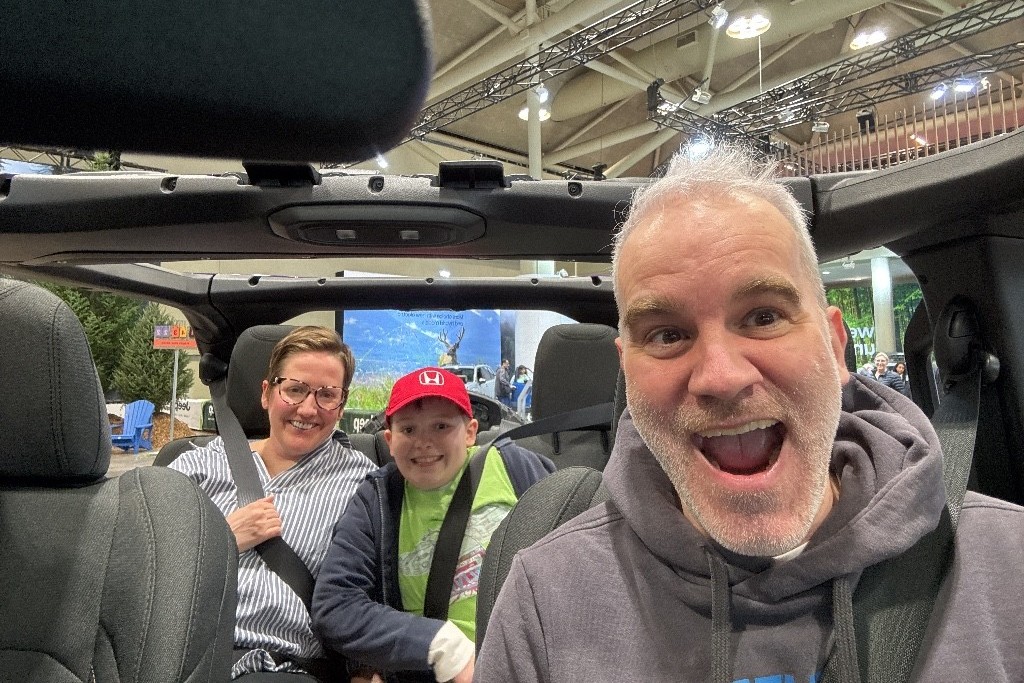 Family taking selfie inside of a car