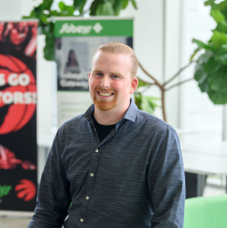 Man in blue button shirt in front of bright open background