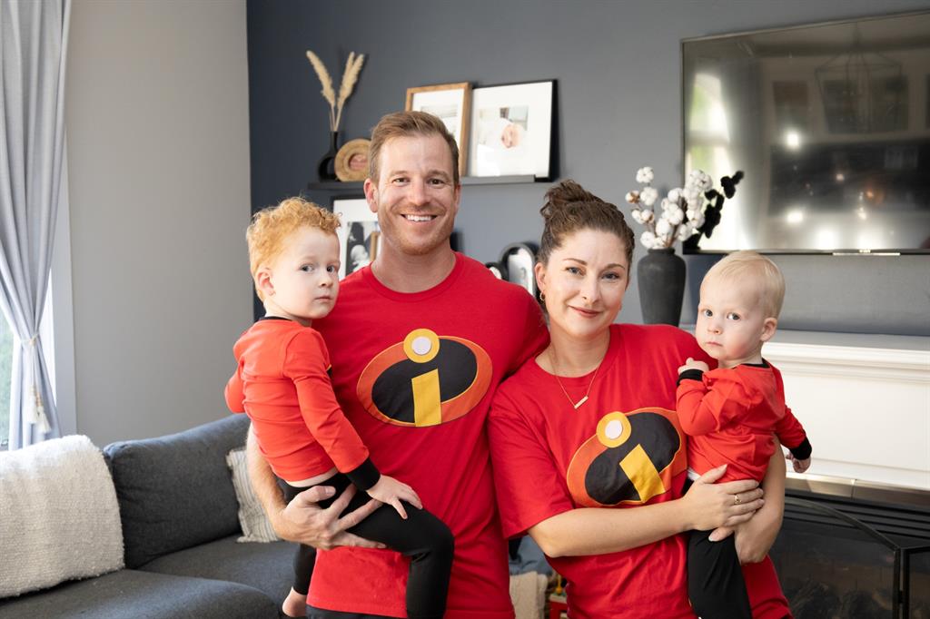 Mom and Dad hold their children in a living room