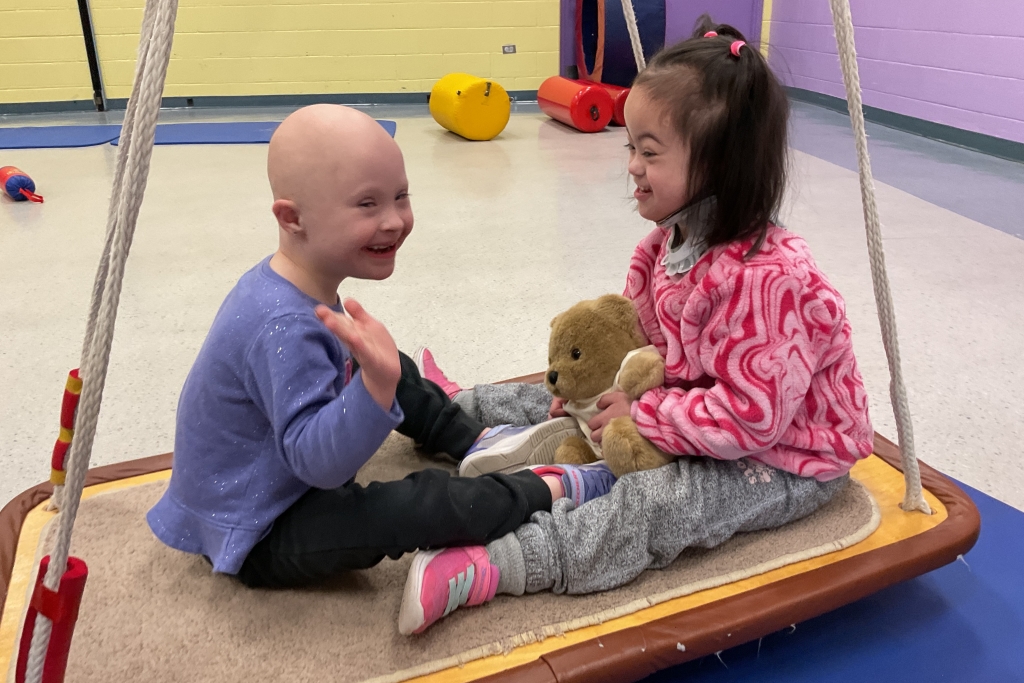 Two female children on a swing