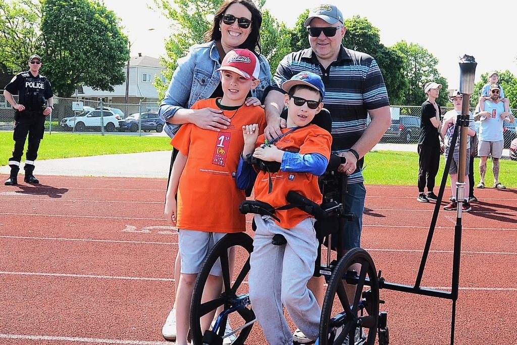 Mother and father with their two sons on running track