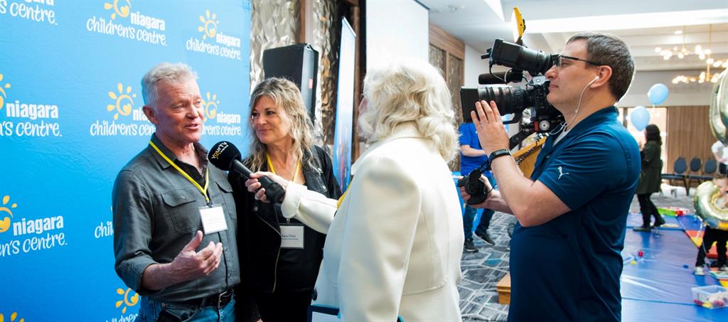 Man and women being interviewed by media at event